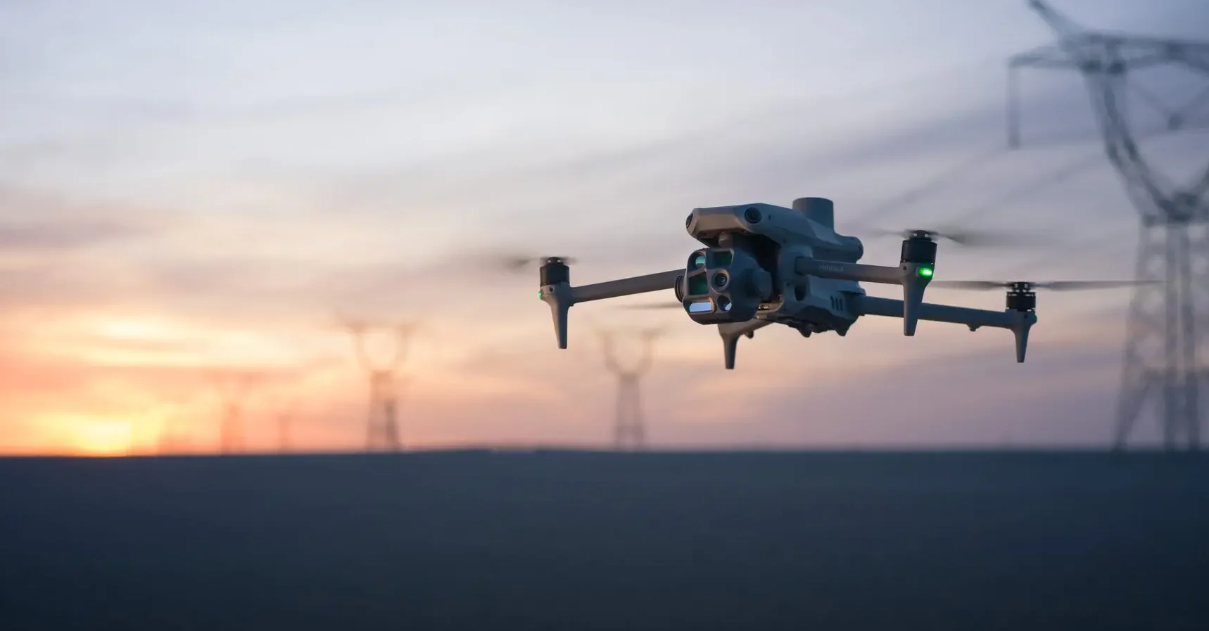 Enterprise drone near power lines at sunset